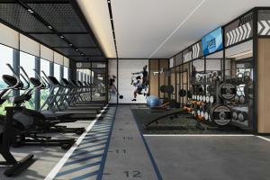 a gym with a row of treadmills and machines at Four Points by Sheraton Guilin Central in Guilin