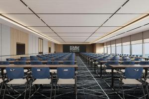 a conference room with tables and chairs and a chalkboard at Four Points by Sheraton Guilin Central in Guilin
