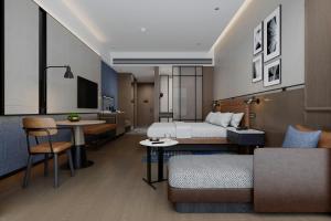a hotel room with a bed and a living room at Four Points by Sheraton Fuzhou Changle in Fuzhou +14 photos