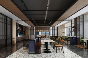 a dining room with tables and chairs and windows at Four Points by Sheraton Fuzhou Changle in Fuzhou