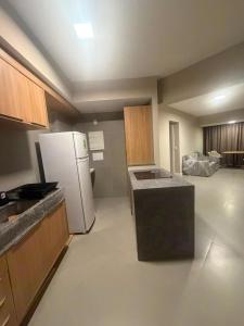 a kitchen with a white refrigerator in a room at View Soft House Apto 1007 in Lauro de Freitas