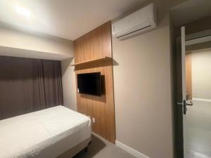 a small bedroom with a bed and a small closet at View Soft House Apto 1007 in Lauro de Freitas +18 photos