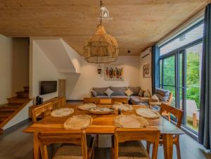 a dining room with a table and a couch at Zanzibar Stays Accommodation Collection, The Soul, Paje in Paje