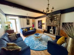 a living room with blue furniture and a fireplace at Liberty House in Ashbourne