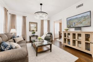 a living room with a couch and a table at Chic Dallas Retreat Trail, Soaking Tub & Patio in Dallas