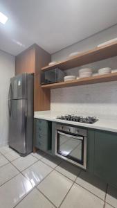 a kitchen with a stove and a refrigerator at Alter Beach in Alter do Chao