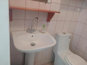 a bathroom with a sink and a toilet at Jambolana Studio in Punaauia +32 photos