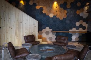 a room with leather chairs and a large table at Hotel Bo in San Cristóbal de Las Casas