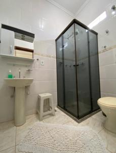 a bathroom with a shower and a sink and a toilet at Pousada Narcizo in São Lourenço +33 photos