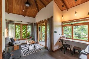 a living room with a couch and a table at Carenero Hills - Beach and Surf Bungalows in Bocas Town