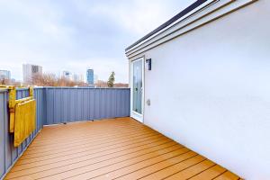 a balcony with a wooden floor and a white wall at Private Rooftop Group Suite near Oriole Park - Eglinton Hotel in Toronto