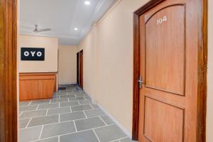 a hallway with a door and a sign on the wall at SPOT ON Hotel Silver Spoon in Dhule
