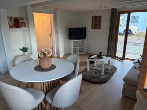a living room with a white table and chairs at Au P'ti Chalet in Souvans