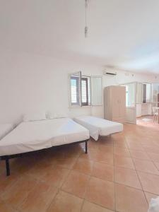 a large white room with a large bed in it at Cuttin Apartment in Gallipoli