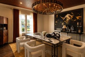 a dining room with a table and chairs and a chandelier at Chic Dallas Retreat Trail, Soaking Tub & Patio in Dallas