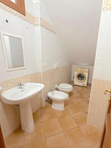 a bathroom with a sink and a toilet at Cuttin Apartment in Gallipoli