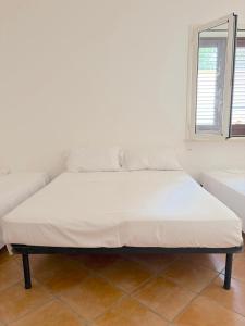 a large bed in a room with a couch at Cuttin Apartment in Gallipoli