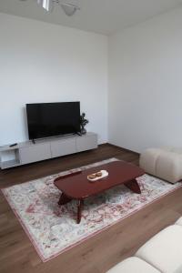 a living room with a tv and a coffee table at Oravelle Loft Kubin in Dolný Kubín