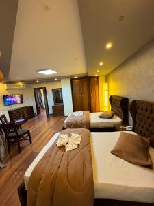 a hotel room with two beds and a tv at Verssailles Al Manar Hotel in Cairo +50 photos