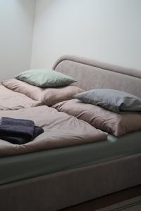 a couch with four pillows on top of it at Oravelle Loft Kubin in Dolný Kubín