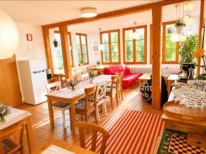 a kitchen and dining room with tables and chairs at Pension Rose-Monteurzimmer & Ferienzimmer - Bodensee-Selbstversorger mit Küchen, Parken & Kaffee & Wlan frei in Ravensburg