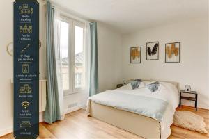 a bedroom with a bed and a large window at Le Courcillon Calme, Cour privée & Proche Château in Versailles