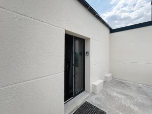 a white building with a door on the side of it at Le Cosy Garibaldi in Sotteville-lès-Rouen