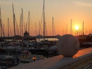 a view of a marina at sunset with boats at Il Sole di Ostia in Lido di Ostia