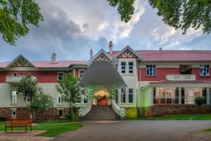 a large red and white house with a stairway at Holiday Inn - Johannesburg Sunnyside Park by IHG in Johannesburg