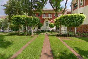 a brick path in front of a house at Holiday Inn - Johannesburg Sunnyside Park by IHG in Johannesburg +61 photos