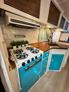 a blue and white stove in a small kitchen at Cozy & Private Tiny House Style in Hickson