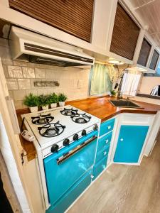 a blue and white stove in a small kitchen at Cozy & Private Tiny House Style in Hickson +10 photos