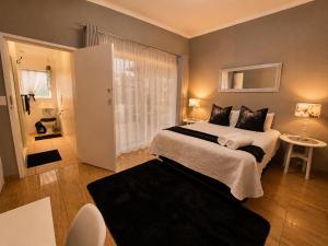 a bedroom with a large bed and a window at Zhantique Guest House 2- Unit 5 in Boksburg