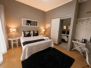 a bedroom with a large bed in a room at Zhantique Guest House 2- Unit 5 in Boksburg