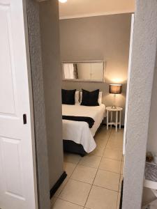 a small bedroom with a bed and a window at Zhantique Guest House 2- Unit 5 in Boksburg