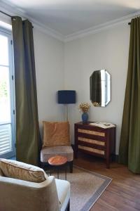 a living room with a couch and a table at Maison Constant - Le Camélia in Autun