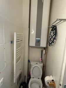 a small bathroom with a toilet and a cabinet at Le Nid Malouin in Saint Malo