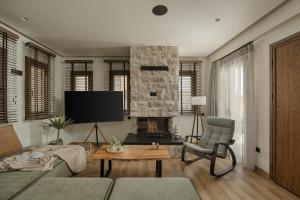 a living room with a couch and a fireplace at Aje Villas 1959 in Ioannina