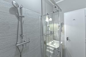 a bathroom with a glass shower and a sink at Hotel Bristol in Trieste +79 photos