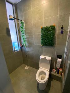 a bathroom with a toilet and a window at Suite Life in Kiambu