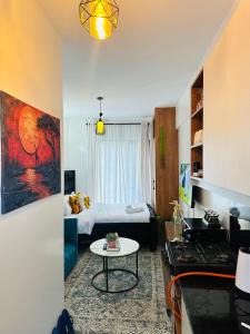 a small living room with a bed and a table at Suite Life in Kiambu