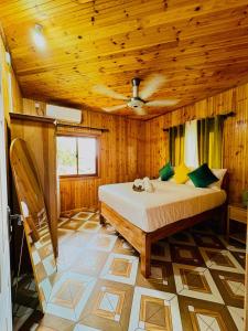 a bedroom with a bed in a wooden room at La Vue De Mer in La Digue