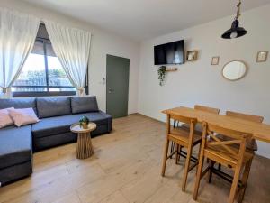 a living room with a blue couch and a table at Noy Hosting in the Golan in Nov