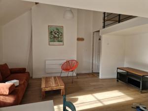 a living room with a couch and a table at Le Logis de Meung Sur Loire in Meung-sur-Loire