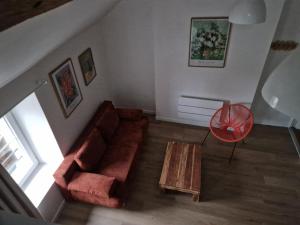 a living room with a couch and a table at Le Logis de Meung Sur Loire in Meung-sur-Loire +1 photo