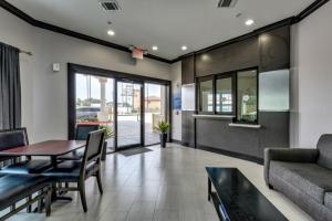 a living room with a table and a couch at Humble Inn & Suites in Humble
