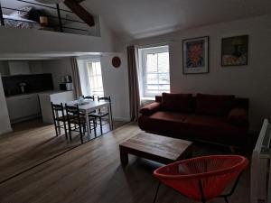 a living room with a couch and a table at Le Logis de Meung Sur Loire in Meung-sur-Loire