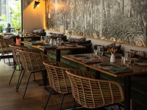 a row of tables and chairs in a restaurant at Manto Hotel Lima - MGallery Collection in Lima