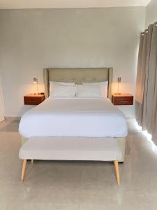 a large bed in a room with two night stands at The Ansen Place in Belmopan +54 photos
