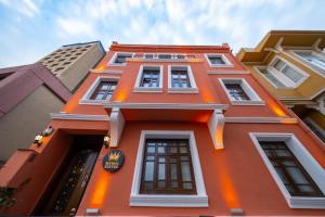 a orange building with many windows on it at The King Suit Beşiktaş in Istanbul